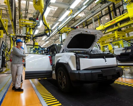 Employees work on the production line at a factory for Chery’s electric vehicles in Wuhu, China