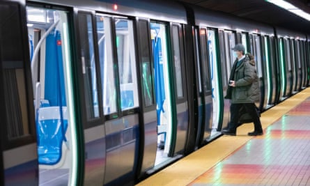 A commuter wearing protective mask boards a subway train in Montreal.