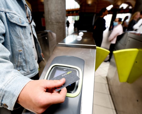 Commuters tapping credit cards on a public transit validator