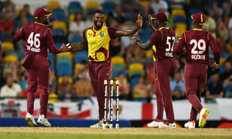 Romario Shepherd of West Indies celebrates with team-mates after taking the wicket of Jason Roy.