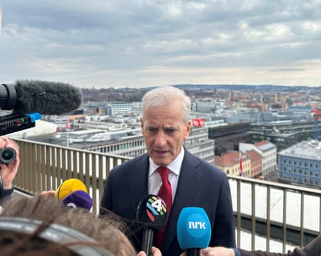 Norway’s prime minister, Jonas Gahr Støre, talks to the press on a terrace of the building housing his new office in Oslo