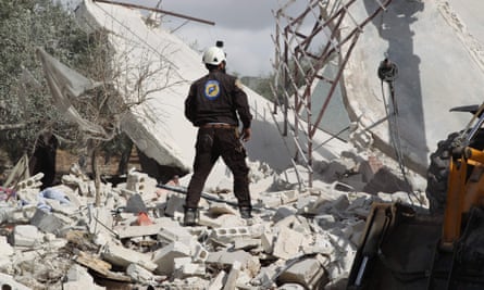 A member of the Syrian White Helmets searches for victims of a Russian airstrike that hit the village of Jaballa on 2 November 2019.