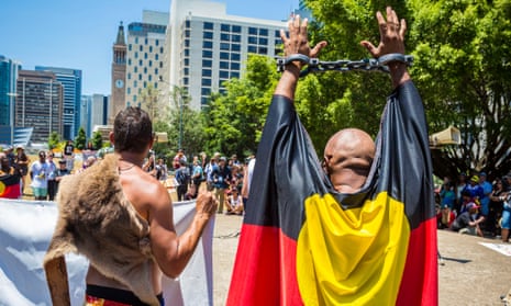 A demonstrator raises his shackled hands during a protest against Indigenous deaths in custody.