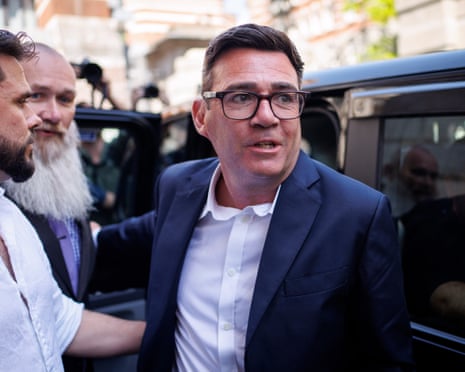 Andy Burnham getting out of a car.