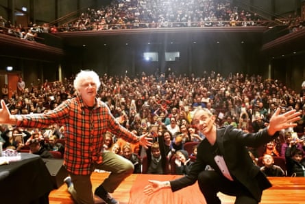 Denton and Andy Griffiths at an event in 2016, with their arms out in front of a theatre audience.