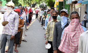 Indian labourers and daily wages workers queue for food in New Delhi, India, 7 April 2020.
