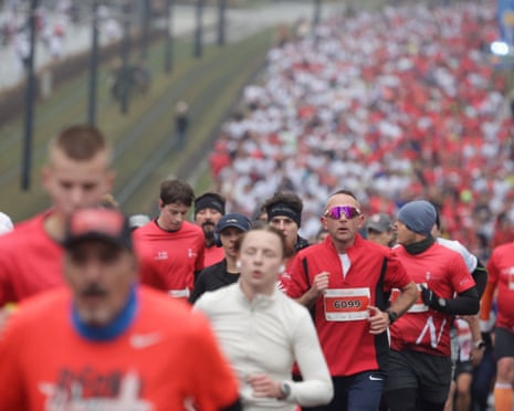 People fill the street as they participate in the Independence Day Run through Warsaw, Poland.