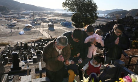 Relatives visit their family’s grave in Iwate prefecture on the sixth anniversary of the Fukushima meltdown this month.