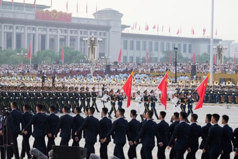 Spectators and military personnel gather ahead of the military parade