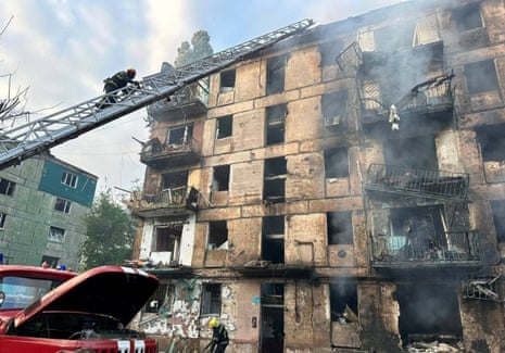Rescuers work at a site of a residential building heavily damaged by a Russian missile strike in Kryvyi Rih.