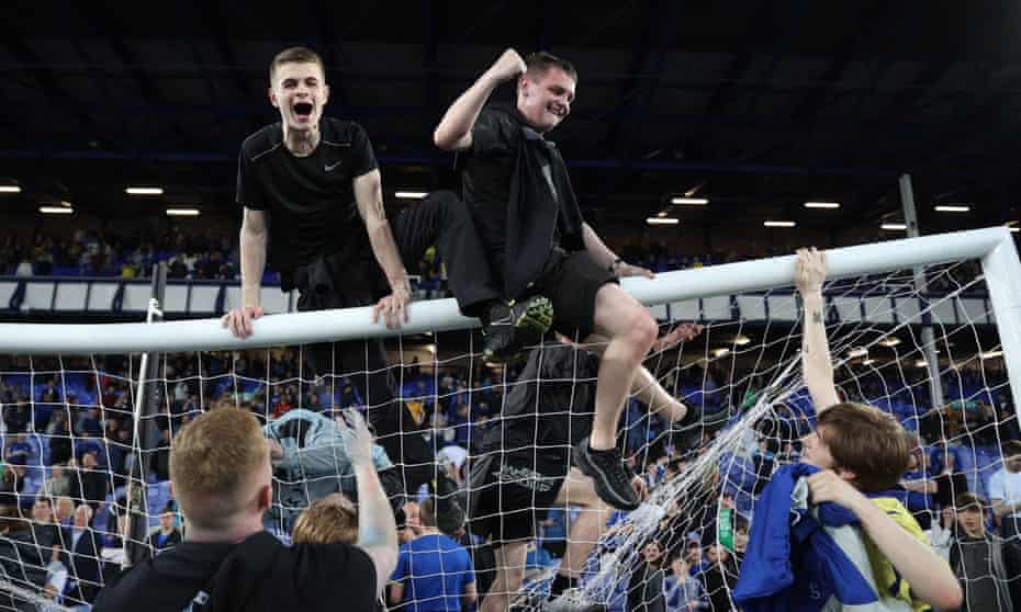 Fans climb on the goal at Goodison Park after Everton's win over Crystal Palace