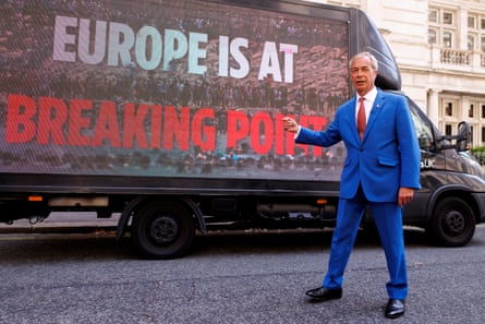 Farage poses with a digital poster van reading ‘Europe is at breaking point’ after a press conference in central London.