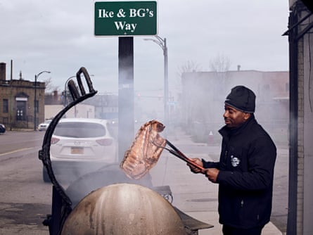 Steven Butler, owner of Ike & BGs, fires up his grill in the cold as he prepares orders for his customers.