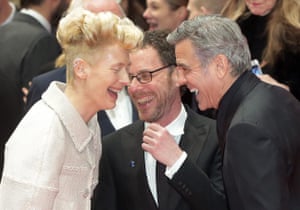 Tilda Swinton, Ethan Coen and George Clooney share a joke on the red carpet