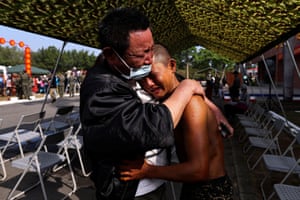 Xie Bo-Jun embraces his father after passing the course