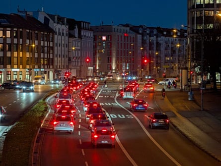 A city road with cars driving along at night in Munich