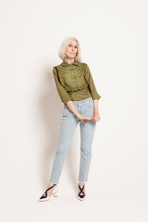 green embroidered shirt with ruffle on front, faded blue jeans French Connection, white and black high heeled pumps