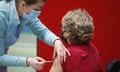 female patient being given NHS vaccine injection