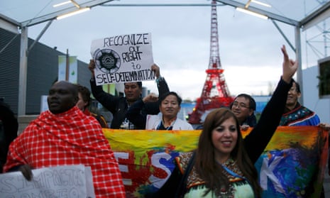 Representative of indigenous peoples stage a protest at the climate change talks in Paris