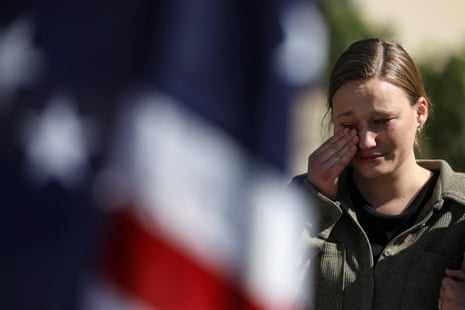 A woman weeps at a memorial to Charlie Kirk at the Timpanogos regional hospital in Orem, Utah.