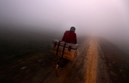 Salit Kumar rides his bike at dawn carrying a box full of polio vaccines to remote villages.