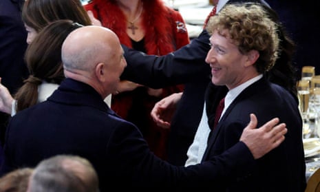 two men speak and smile at each other