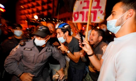 Israeli police officers remove protesters from the street in Jerusalem.