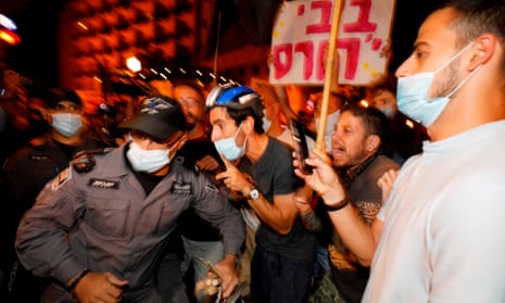 Israeli police officers remove protesters from the street in Jerusalem.