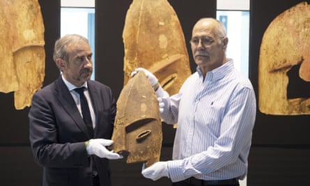John Johnson, right, of the Chugach Alaska Corporation with Hermann Parzinger, the president of the Prussian cultural heritage foundation, show an item plundered from the graves of indigenous Alaskans.