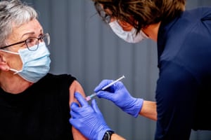 A doctor vaccinates a woman with AstraZeneca’s Covid vaccine in the Netherlands.