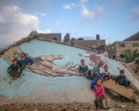 Children surrounded by damaged buildings in Gaza