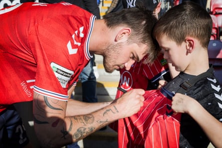 York’s Zak Johnson signs a shirt after the game.
