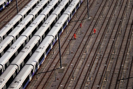 Railway workers and trains at Old Oak Common in west London.