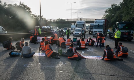 Protesters from Insulate Britain block the M25 motorway near Cobham in Surrey