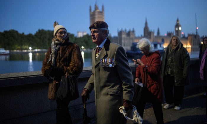 On Saturday morning, people line up near the Houses of Parliament to pay their respects after the Queen's death.