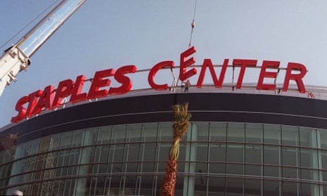 Construction workers put the finishing touches on the Staples Center sign outside the arena in downtown Los Angeles on 16 September 1999. 