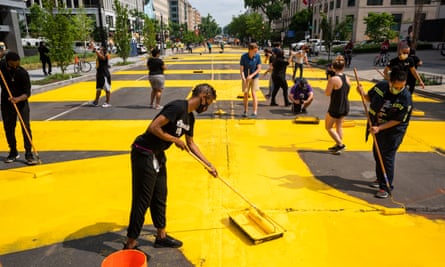 With permission from the city, volunteers paint ‘Black Lives Matter’ on 16th St across from the White House on Friday.