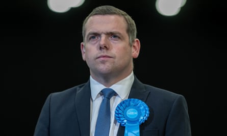 Douglas Ross, wearing a Conservative rosette, at the count in Aberdeen