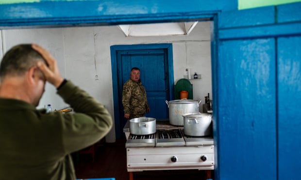 Ukrainian soldiers in the kitchen of a local school
