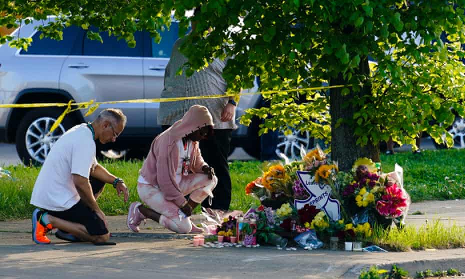 People pay their respects outside the scene of a shooting at a supermarket in Buffalo, New York, on Sunday.