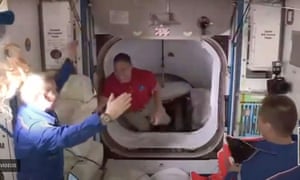 Crew are greeted as they disembark the Crew Dragon capsule at the international space station.