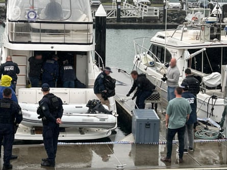 Police remove the alleged blocks of cocaine from the boat.