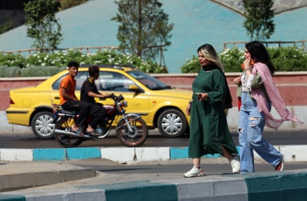 People walk on a street in Tehran, Iran
