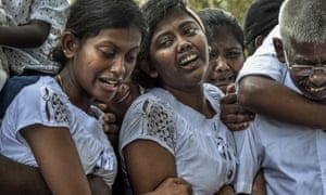 Mourners grieve at the graves of relatives killed in the Easter Sunday bombingsin Sri Lanka. Journalists question their presence at deeply personal times such as these.