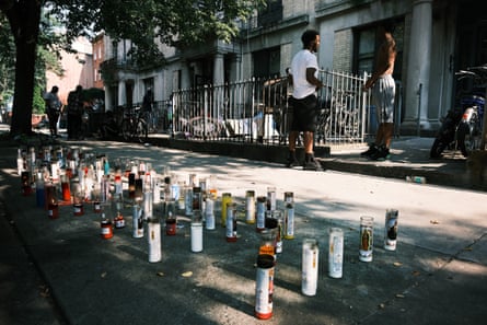 Candles mark the spot where a young man was shot and killed in July 2021.