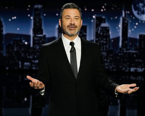 a man in a suit and tie speaks