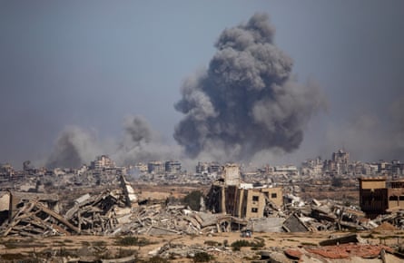 Smoke rises in the air above damaged and destroyed buildings