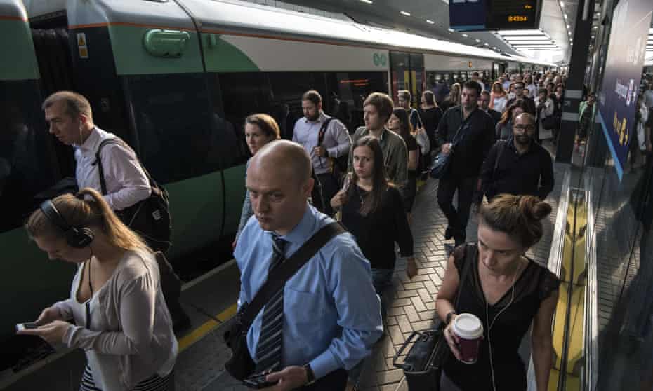 Commuters disembark a rush hour Southern Rail train at London Bridge