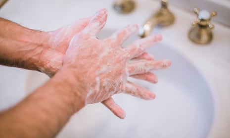 male hands being washed in bathroom sink