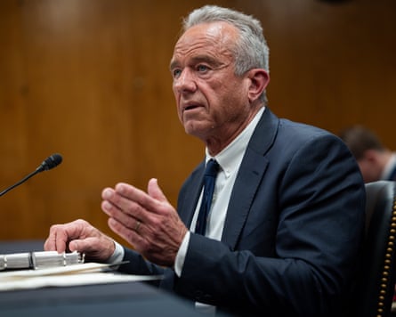 Robert F Kennedy Jr gestures arsenic he speaks successful a microphone connected a table